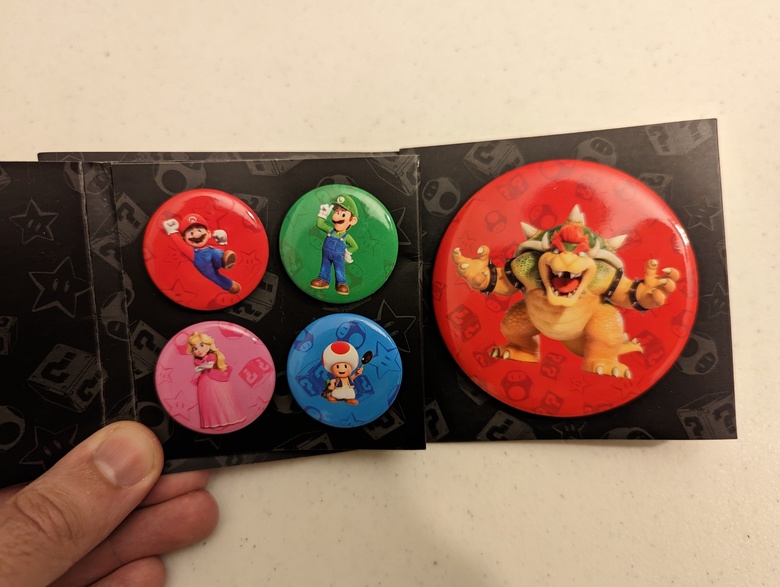 Pins featuring the new depictions of the characters